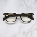 An image of the GR10 Square Opticals in Multi Havana frame frontal view with arms closed marble background