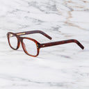 An image of the 0847 Kingsman Aviator Opticals (Small) in Red Havana frame side view with arms open marble background