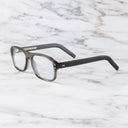 An image of the 0847 Kingsman Aviator Opticals (Small) in Pewter Grey frame side view with arms open marble background