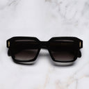 An image of the The Great Frog Bones Link Rectangle Sunglasses in Black frame frontal view with arms closed marble background 