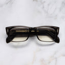 An image of the The Great Frog Dagger Square Optical Glasses in Pewter Grey frame frontal view with arms closed marble background 