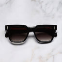 An image of the The Great Frog Lucky Diamond I Round Sunglasses in Black frame frontal view with arms closed marble background 