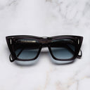 An image of the The Great Frog Love And Death Cat Eye Sunglasses in Dark Grey frame frontal view with arms closed marble background 