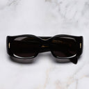 An image of the The Great Frog Diablo Limited Edition Rectangle Sunglasses in Black Gold frame frontal view with arms closed marble background