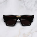 An image of the The Great Frog Prometheus Square Sunglasses in Black on Red frame frontal view with arms closed marble background 