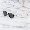 An image of the Cutler and Gross The Great Frog Carol Rectangular Sunglasses in silver frame side view with arms open marble background.