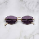 An image of the Cutler and Gross The Great Frog Carol Rectangular Sunglasses in gold/silver frame frontal view with arms closed marble background.