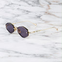 An image of the Cutler and Gross The Great Frog Carol Rectangular Sunglasses in gold/silver frame side view with arms open marble background.