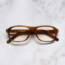 An image of the 0847 Kingsman Optical Aviator Glasses in Striped Mustard Havana frame frontal view with arms closed marble background 